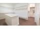 Large walk-in closet featuring custom shelving, an island, plus access to the laundry room at 159 Colony Point Dr, Punta Gorda, FL 33950