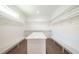 Bright walk-in closet with custom shelving, a center island, and laminate flooring at 159 Colony Point Dr, Punta Gorda, FL 33950