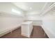 Spacious walk-in closet with custom shelving, an island, and laminate flooring at 159 Colony Point Dr, Punta Gorda, FL 33950