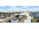 Aerial shot shows a canal community with homes, docks, and boat lifts at 1954 Arkansas Ave, Englewood, FL 34224