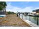 Canal backyard with a dock and lush greenery at 1954 Arkansas Ave, Englewood, FL 34224