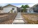 Backyard featuring a screened lanai, a path of stepping stones, and views of the surrounding greenery at 1954 Arkansas Ave, Englewood, FL 34224