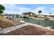Waterfront backyard with a dock and boat lift, perfect for boating and enjoying the canal lifestyle at 1954 Arkansas Ave, Englewood, FL 34224