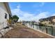 Backyard with a canal view, offering a serene waterfront setting with potential for landscaping at 1954 Arkansas Ave, Englewood, FL 34224