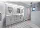 Modern bathroom with double vanity, white cabinetry, and a walk-in shower creating a clean and bright space at 1954 Arkansas Ave, Englewood, FL 34224