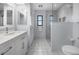 Bright bathroom features a white vanity, walk-in shower, and tiled floors at 1954 Arkansas Ave, Englewood, FL 34224