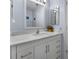 Beautiful bathroom featuring a white vanity with a marble countertop, modern fixtures, and a mirror at 1954 Arkansas Ave, Englewood, FL 34224