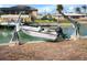 White boat lifted on a boat lift in the canal at 1954 Arkansas Ave, Englewood, FL 34224