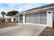 Exterior view of the home featuring a large garage door and extended driveway at 1954 Arkansas Ave, Englewood, FL 34224
