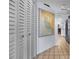 Hallway features a nautical map and white louvered closet doors at 1954 Arkansas Ave, Englewood, FL 34224