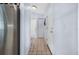 Hallway features neutral tile, stainless fridge, and white doors at 1954 Arkansas Ave, Englewood, FL 34224