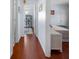 The well-lit hallway has hardwood floors and provides access to different rooms in the house at 1954 Arkansas Ave, Englewood, FL 34224
