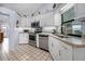 Kitchen features white cabinetry and stainless steel appliances at 1954 Arkansas Ave, Englewood, FL 34224