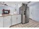 Kitchen with stainless refrigerator and open view to the living room at 1954 Arkansas Ave, Englewood, FL 34224