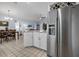 Kitchen with stainless refrigerator and open view to the dining room at 1954 Arkansas Ave, Englewood, FL 34224