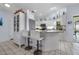 Kitchen bar with white stools and decor at 1954 Arkansas Ave, Englewood, FL 34224