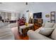 Inviting living room features wood floors, fireplace, flatscreen TV, and comfortable seating at 1954 Arkansas Ave, Englewood, FL 34224