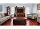 Comfortable living room with hardwood floors, sofa, seating, entertainment center, and natural light at 1954 Arkansas Ave, Englewood, FL 34224