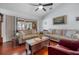 Cozy living room with hardwood floors, neutral tones, and comfortable seating, ideal for relaxing and entertaining guests at 1954 Arkansas Ave, Englewood, FL 34224