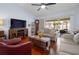 Cozy living room includes wood floors, modern fireplace, comfortable seating, and screened patio at 1954 Arkansas Ave, Englewood, FL 34224