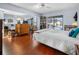 Bright main bedroom features wood floors and a large glass sliding door to the patio/pool area at 1954 Arkansas Ave, Englewood, FL 34224