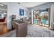 Bright home office boasts wood floors, large desk, and a sliding glass door out to screened pool at 1954 Arkansas Ave, Englewood, FL 34224