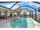 Screened pool with canal view and outdoor seating area at 1954 Arkansas Ave, Englewood, FL 34224