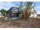 A screened-in pool area surrounded by lush greenery, providing privacy and shade at 1954 Arkansas Ave, Englewood, FL 34224