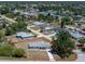 An aerial view showing the property boundaries of the house with the gray roof in a leafy neighborhood at 7330 Regina Dr, Englewood, FL 34224