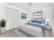 Stylishly furnished bedroom with calming blues, soft lighting, and spacious closet at 7330 Regina Dr, Englewood, FL 34224