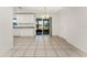 Bright dining area with white cabinets, granite countertops, and sliding glass doors to the outside at 7330 Regina Dr, Englewood, FL 34224