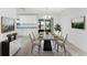Elegant dining room with stylish chairs, a modern table, and seamless access to outdoor views at 7330 Regina Dr, Englewood, FL 34224
