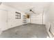 Spacious garage with ample storage space and a functional garage door at 7330 Regina Dr, Englewood, FL 34224
