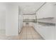 Modern kitchen featuring white cabinets, granite countertops, and stainless steel appliances at 7330 Regina Dr, Englewood, FL 34224