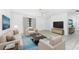 Inviting living room featuring contemporary furnishings, a ceiling fan, and tile flooring at 7330 Regina Dr, Englewood, FL 34224