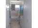 Cozy bathroom featuring tiled walls, tub with shower, and a bright window at 91 Gasparilla Way, Placida, FL 33946