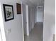 Well-lit hallway with white doors and neutral tones, offering access to various rooms in the home at 91 Gasparilla Way, Placida, FL 33946