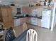 Spacious kitchen with light wood cabinets and modern appliances, perfect for culinary enthusiasts at 91 Gasparilla Way, Placida, FL 33946