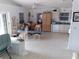 Open living room with natural light, tile flooring and a ceiling fan at 91 Gasparilla Way, Placida, FL 33946