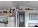 Living area showcasing kitchen and hallway beyond, with coastal decor and ample natural light at 91 Gasparilla Way, Placida, FL 33946