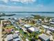 Aerial view of waterfront property with canal access, boat dock, and beautifully landscaped yard at 9240 Pine Cove Dr, Englewood, FL 34224