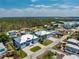 Aerial view of waterfront homes, canals, and lush green surroundings on a sunny day at 9240 Pine Cove Dr, Englewood, FL 34224