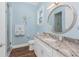 This light blue bathroom has a granite countertop and a separate walk-in shower at 9240 Pine Cove Dr, Englewood, FL 34224