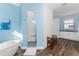 Bright bathroom featuring a modern tub, walk-in shower, and vanity with elegant finishes at 9240 Pine Cove Dr, Englewood, FL 34224