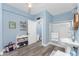 Bright bathroom with a glass-enclosed shower, vanity, coastal decor, and blue walls for a fresh, airy feel at 9240 Pine Cove Dr, Englewood, FL 34224