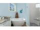 Relax in this bathroom featuring a soaking tub with a waterfall faucet, surrounded by nautical decorations at 9240 Pine Cove Dr, Englewood, FL 34224