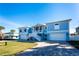 Charming home exterior featuring a well-manicured lawn and a paver driveway at 9240 Pine Cove Dr, Englewood, FL 34224