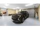 Spacious garage featuring an SUV, epoxy flooring, and ample storage space at 9240 Pine Cove Dr, Englewood, FL 34224