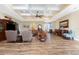 Open concept living room with wood floors, coffered ceilings, and comfortable seating arrangements at 9240 Pine Cove Dr, Englewood, FL 34224
