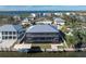 Rear exterior view of home with screened in lanai, boat dock, and waterfront at 9240 Pine Cove Dr, Englewood, FL 34224